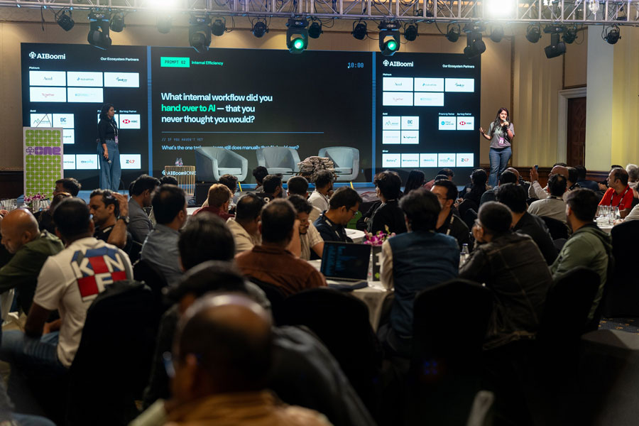 Fireside chat on stage with the audience seated at round tables