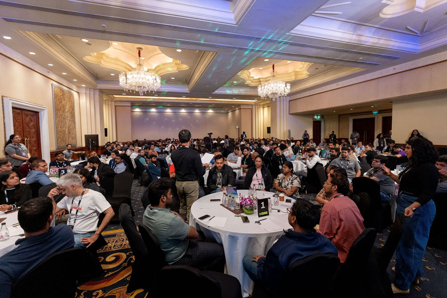 Packed ballroom of founders seated at round tables